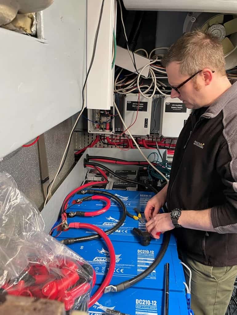 Mic Harrison, lead engineer for Merlin Equipment is installing Fullriver DC batteries into a Sunseeker yacht.