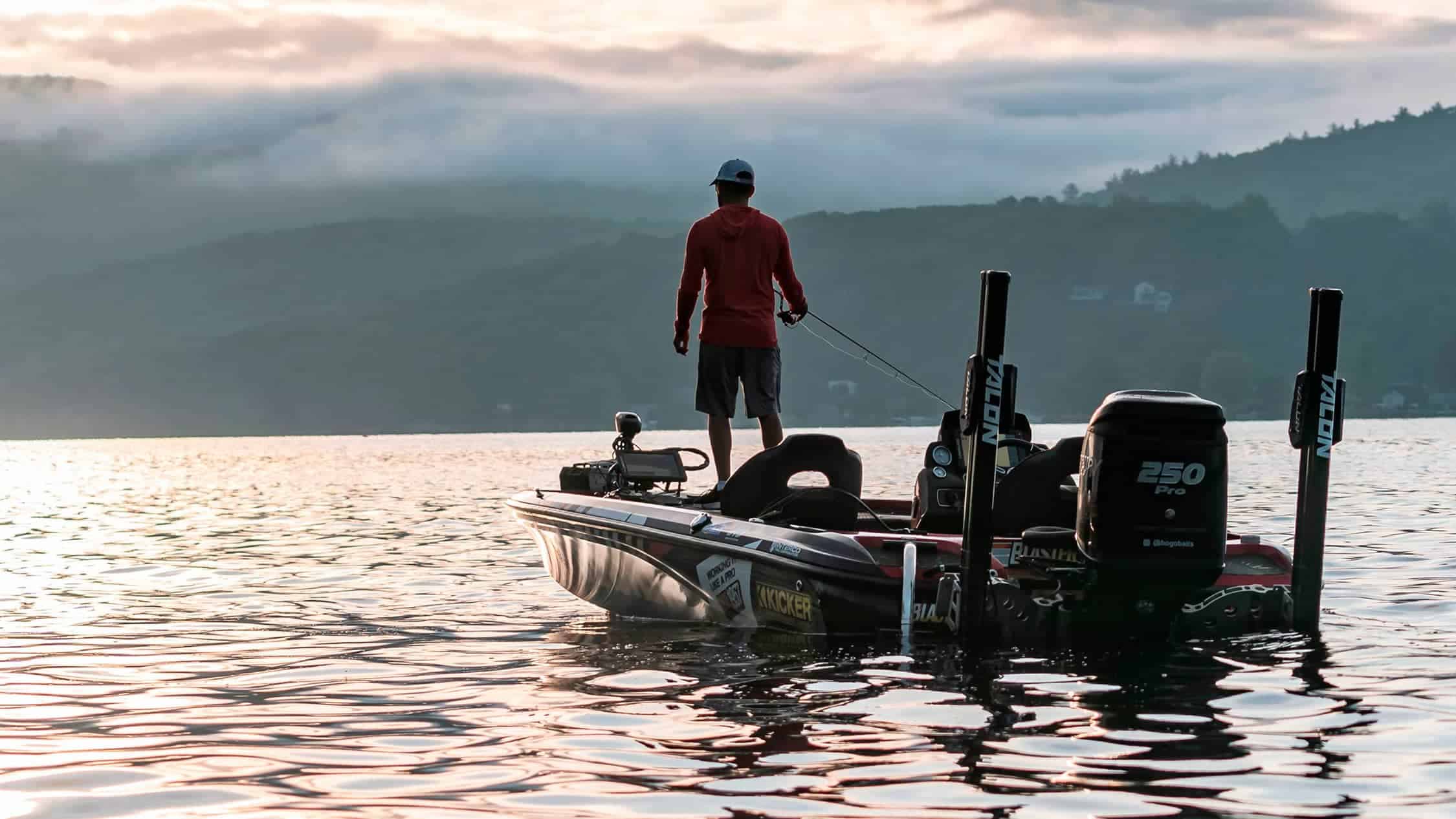 Bass fishing boat on the water at sunset